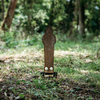 Assembled raw 16" steel popper ground stake target stomped into the dirt
