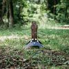 12" Spring popper target - painted base & raw auto-resetting target in the woods