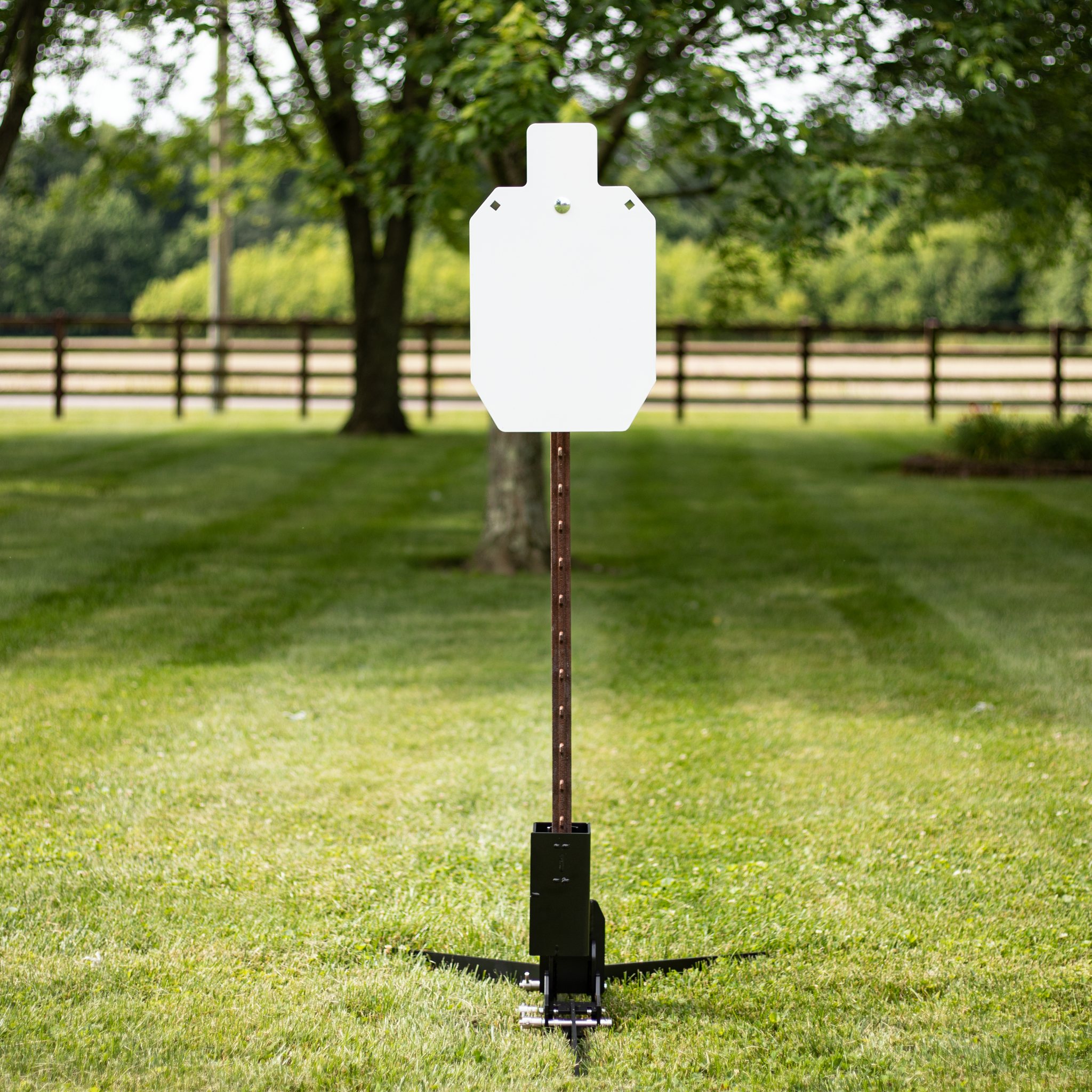 Steel target mounted on adjustable T-post shooting stand at outdoor range