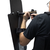 right handed officer holding a 15" x 25" Caliber Armor Rifle rated Level III+ RF2 Ballistic Shield with pivoting handle mounted for left handed use aiming through a pistol with sight 