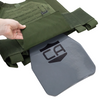 Green tactical vest with a gray steel hard armor plate being inserted into the bottom of the plate carrier, plate  features a CA logo on a white background