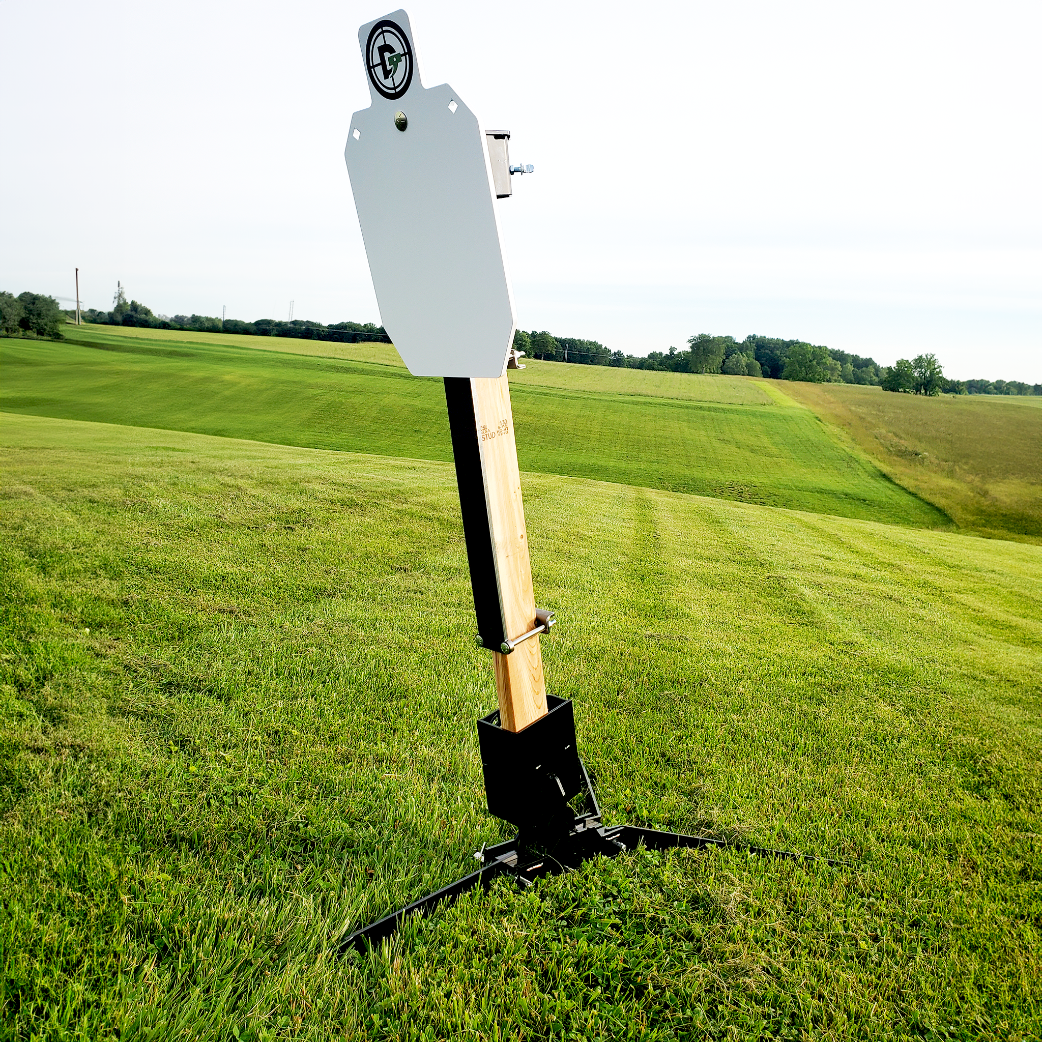 20 inch AR500 protector plate installed on 2x4 steel target stand upright at outdoor range