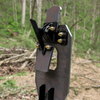 backside view of ar500 vital strike reactive target mounted on a 2x4 showing the head in the up position, hit the head  & it will fall back flat against the black arm that is attached to the chest paddle