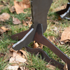 Close-up of stand leg installed onto the foot of a sasquatch teel shooting target on grassy ground