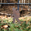 Large silhouette of a bigfoot shape meant for rimfire target shooting hanging from stand