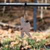 Small silhouette of a bigfoot shape meant for rimfire target shooting hanging from stand