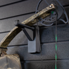 close up of black plastic hanger for compound bow shown mounted to a black tactical gear slat wall named Assault Wall with a cammo bow hung from the upper limb