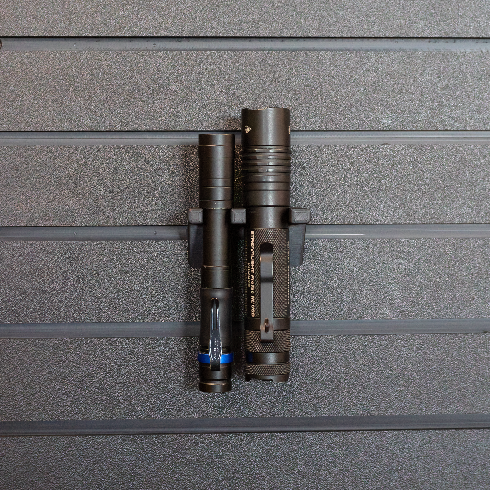 Tactical flashlight wall hanging mount, holding 2 flashlights shown mounted from our Assault Wall tactical slat wall