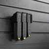 Black pistol magazine hanger showing both 9mm & 40 cal magazines installed into mount and hung on an Assault Wall tactical slat wall panel, 3 magazine capacity