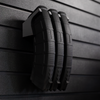 Three black AK-47 magazines stacked on mag slat wall hanger, installed on an Assault Wall tactical slat wall