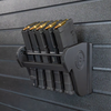 Assault Wall Universal Mag Holder with doublet tap logo with adjustable tension, shown loaded with loaded rifle mags & mounted to a black Assault Wall panel, highlighting the adjustable slot options that the carbon fiber rod rests in