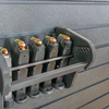 Assault Wall Universal Mag Holder with adjustable tension, shown loaded with pistol mags organized & mounted to a black Assault Wall panel, highlighting the adjustable slot options that the carbon fiber rod rests in