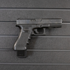 Right facing black plastic magazine mounted 40 cal pistol hanger installed on Assault Wall Tactical slat wall