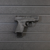 Right facing black plastic magazine mounted 9mm single stack pistol hanger installed on Assault Wall Tactical slat wall