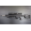 Assault Wall magazine mounted hanger for AR10 rifles, Left facing mount with gun hanging from mag well on a black Assault Wall slat wall panel