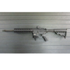 Assault Wall magazine mounted hanger for .22LR-AR15 rifles, Left facing mount with gun hanging from mag well on a black Assault Wall slat wall panel