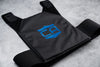 Black gray man carrier provides discreet protection with low profile soft armor laying flat on ground