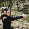 Double Tap Industries bluetooth noise canceling noise enhancement headphones for hearing protection at the shooting range open on female model at shooting range