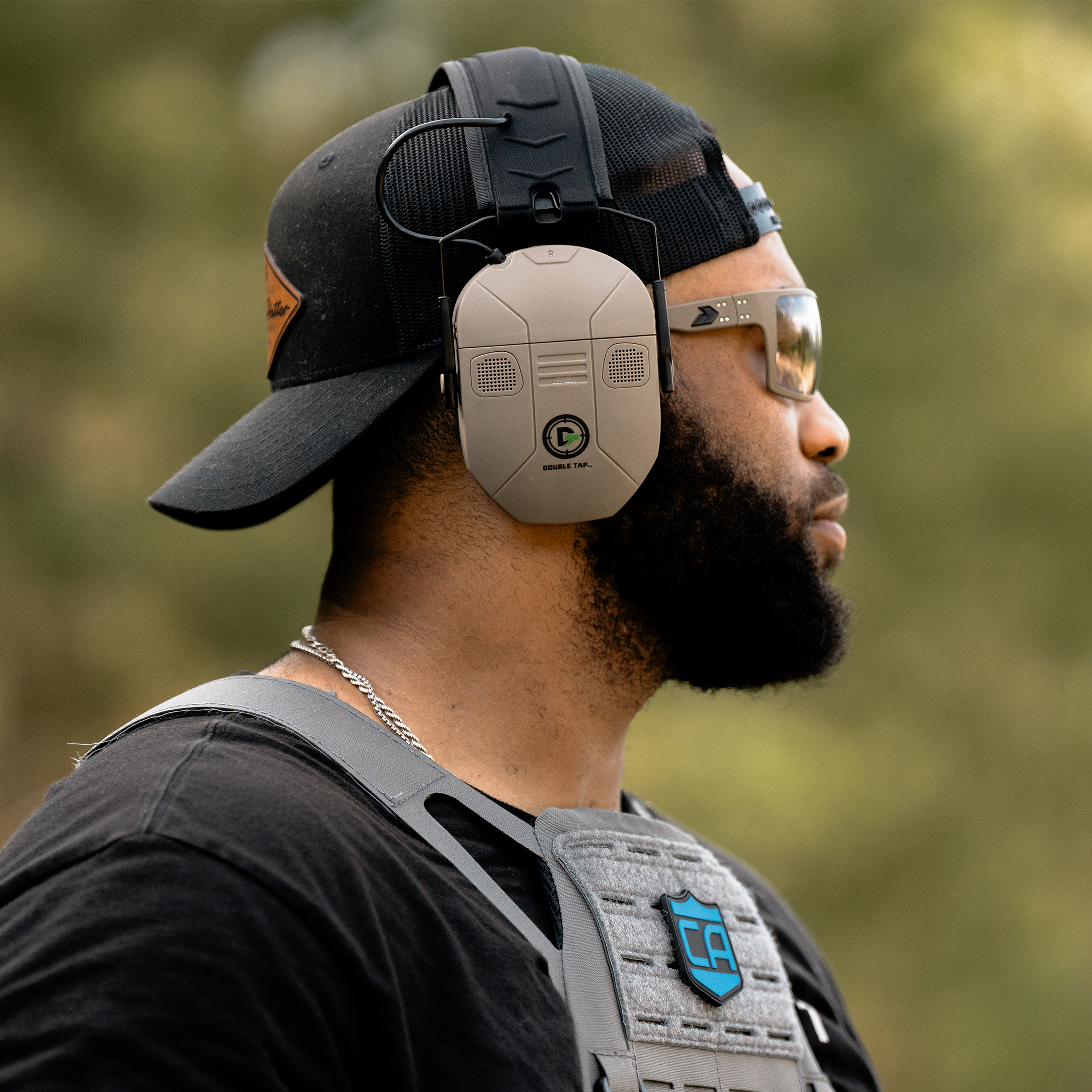 Double Tap Industries bluetooth noise canceling noise enhancement headphones for hearing protection at the shooting range on model at shooting range