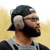 Double Tap Industries bluetooth noise canceling noise enhancement headphones for hearing protection at the shooting range open on male model at shooting range