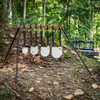 Double tap industries rubber straps assembled with gongs at outdoor range hanging on conduit stand with a 2x4
