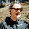 Female shooter wearing double tap industries bluetooth headphones for all day hearing protection comfort at a shooting range