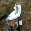 double tap industries white powder coated t post hanger sitting on t post holding rubber strap with ar500 steel gong