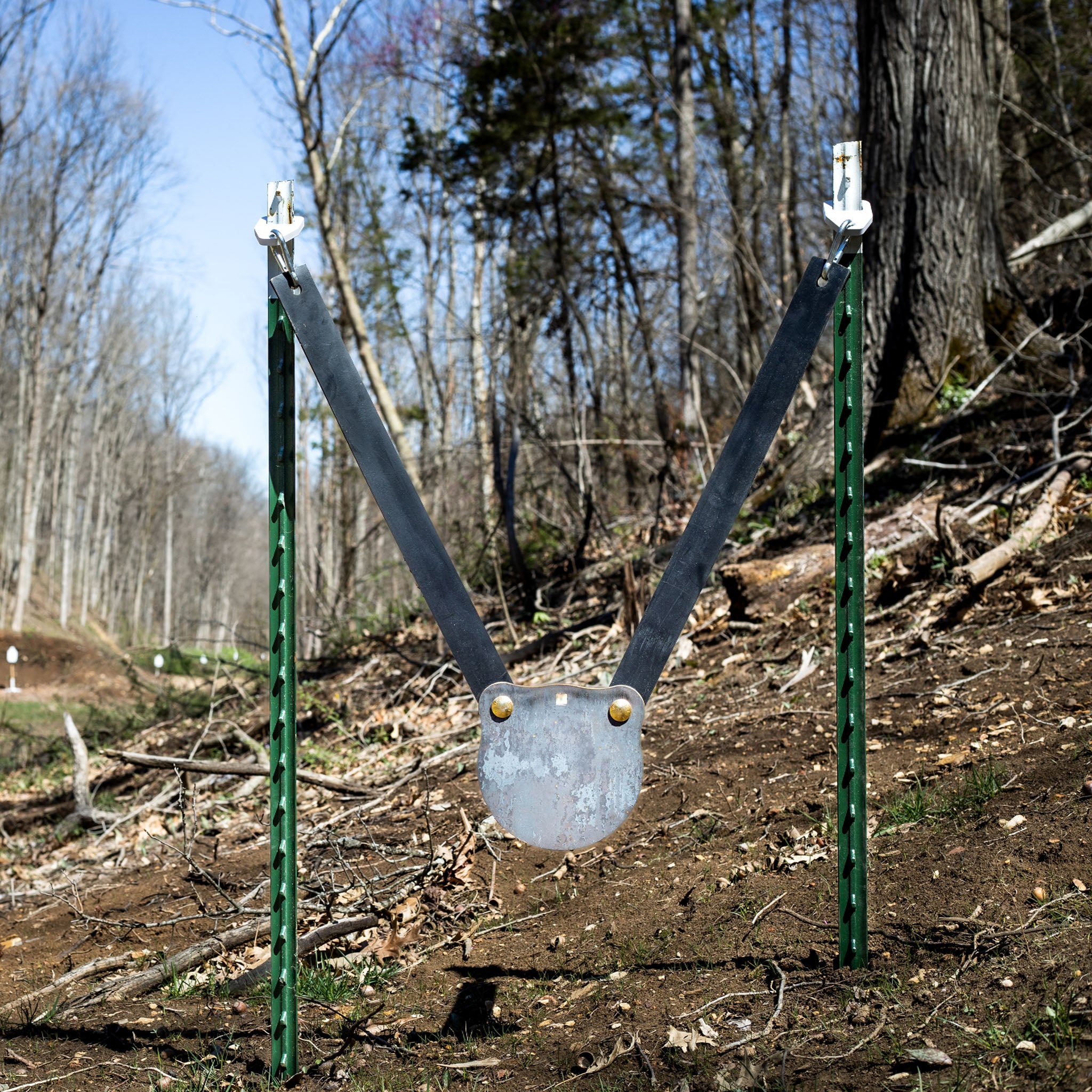 double tap industries steel gong target mounted to T-post hanger system at shooting range
