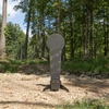 AR500 fall popper with base for forward or rear falling with a 33 inch classic ipsc popper target in wooded surroundings