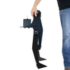 Shooter carrying folded portable 2x4 steel target base with spiked feet on a white background