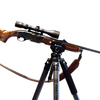 rifle in saddle clamp mounted on carbon fiber shooting tripod on a white background