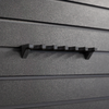 Close-up of a six shotgun shell hanger without shells loaded that has been mounted to an Assault Wall tactical slat wall panel
