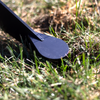 spiked foot of adjustable 2x4 base inserted in the ground at an outdoor range