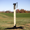 Steel target mounted on adjustable 2x4 stand with 3-legged spiked feet at shooting range
