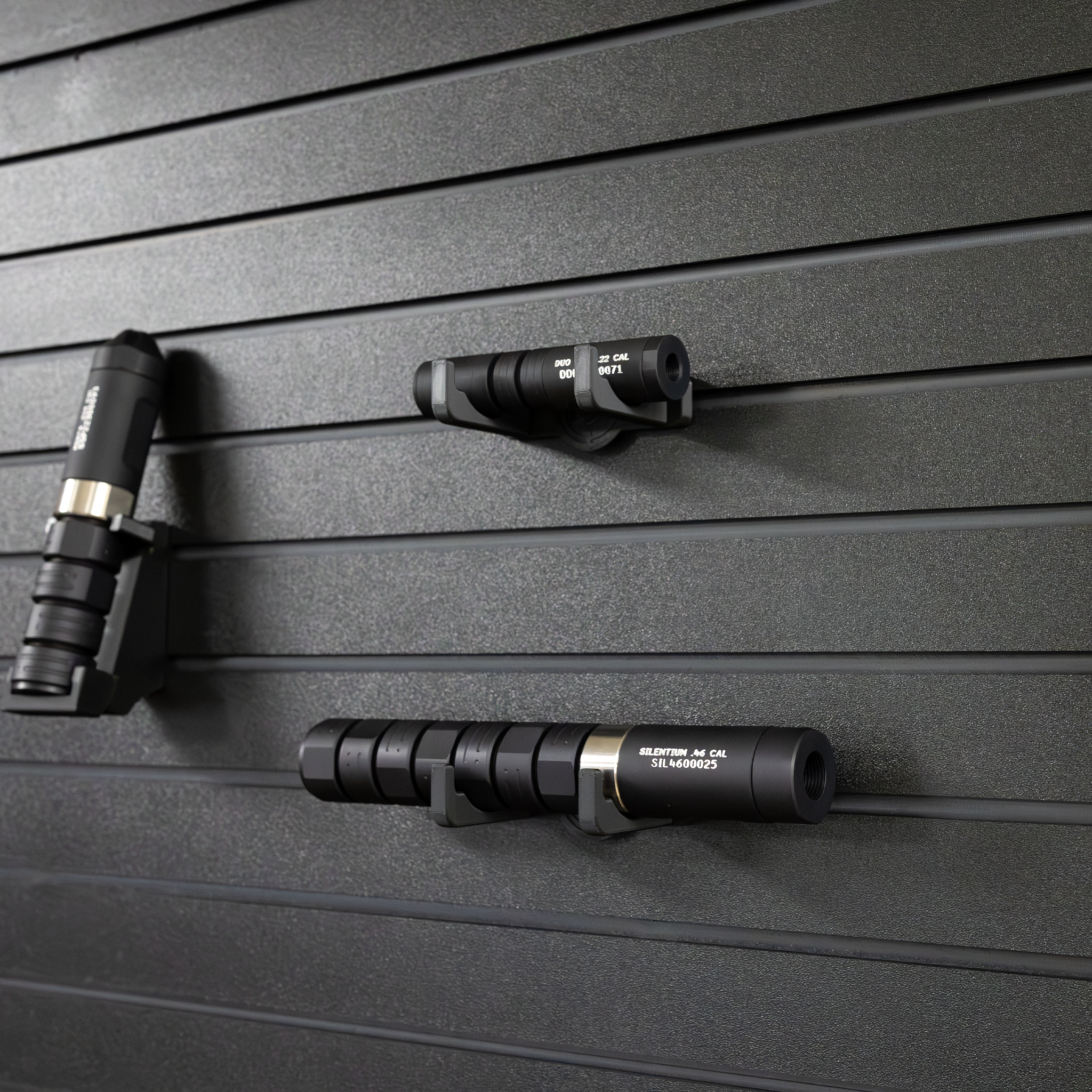 Suppressor stored on Assault Wall vertical suppressor holder both vertically and horizontally